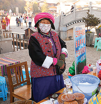 This happy woman is hawking yak yoghurt and barley cookies